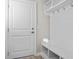 Functional mudroom area with storage hooks, shelves, and a bench near the entrance at 377 Starlit Way, Myrtle Beach, SC 29579