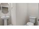 Elegant powder room featuring a pedestal sink, a round mirror, and modern fixtures for a convenient guest space at 377 Starlit Way, Myrtle Beach, SC 29579