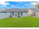 Backyard featuring a green lawn, a small patio and a light blue siding at 460 Boundary Ave., Murrells Inlet, SC 29576