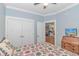 Bedroom featuring a cozy quilt, ceiling fan, and doorway looking into the kitchen area at 460 Boundary Ave., Murrells Inlet, SC 29576