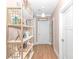 Hallway features warm wood floors, white doors, shelving, and natural light, creating a cozy atmosphere at 460 Boundary Ave., Murrells Inlet, SC 29576