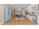Charming kitchen with white cabinets, stainless steel appliances, and a cozy dining area with blue chairs at 460 Boundary Ave., Murrells Inlet, SC 29576