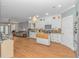 Open-concept kitchen with white cabinets, a butcher block island, modern appliances, and hardwood floors at 460 Boundary Ave., Murrells Inlet, SC 29576
