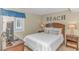 Bedroom with comfortable bed, TV, and coastal decor at 609 Hillside Dr. S # E - 10, North Myrtle Beach, SC 29582