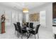 Elegant dining room with modern lighting, stylish decor, and views of the outdoors at 6105 Bolsena Place, Myrtle Beach, SC 29577