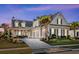 Charming two-story home with a well-manicured lawn, a three-car garage, and a welcoming front porch at 6105 Bolsena Place, Myrtle Beach, SC 29577