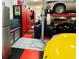 Spacious garage with a car lift, ample storage cabinets, and a checkerboard floor, perfect for car enthusiasts at 6105 Bolsena Place, Myrtle Beach, SC 29577