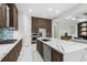 Gourmet kitchen with a large island, stainless steel appliances, and stylish backsplash at 6105 Bolsena Place, Myrtle Beach, SC 29577