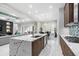 Open concept kitchen offers island with seating, seamlessly flowing into the living area at 6105 Bolsena Place, Myrtle Beach, SC 29577