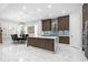 Modern kitchen featuring a marble-topped island, dark wood cabinets, and stainless steel appliances at 6105 Bolsena Place, Myrtle Beach, SC 29577