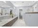 This primary bathroom features dual sink vanity, a walk in shower, and modern finishes at 6105 Bolsena Place, Myrtle Beach, SC 29577