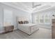This spacious main bedroom offers a ceiling fan, plentiful natural light, and neutral decor at 6105 Bolsena Place, Myrtle Beach, SC 29577