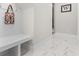 Stay organized with this mud room featuring a bench, hooks, and durable tile flooring at 6105 Bolsena Place, Myrtle Beach, SC 29577