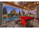 Inviting covered patio with a comfortable seating area, a grill, and a view of the backyard pool at 6105 Bolsena Place, Myrtle Beach, SC 29577