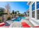 Stunning backyard pool with a stone waterfall feature and lush landscaping, creating a private oasis at 6105 Bolsena Place, Myrtle Beach, SC 29577