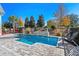 A beautiful swimming pool and waterfall feature with a fenced yard and comfortable seating at 6105 Bolsena Place, Myrtle Beach, SC 29577