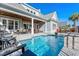Beautiful backyard pool with an outdoor seating area and covered patio, perfect for entertaining at 6105 Bolsena Place, Myrtle Beach, SC 29577