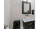 Modern powder room with black accents and a modern vessel sink and large mirror at 6105 Bolsena Place, Myrtle Beach, SC 29577
