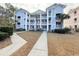 Three-story light blue building with walkway and landscaping at 640 Waterway Village Blvd # 15 I, Myrtle Beach, SC 29579