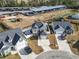 Aerial view of a home in a suburban neighborhood with manicured lawns and two car garages at 724 Hobonny Loop, Longs, SC 29568