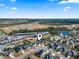 Aerial view of a residential neighborhood with blue skies above and beautiful landscaping at 724 Hobonny Loop, Longs, SC 29568