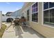 Back patio featuring outdoor table, grill, and view of back door at 724 Hobonny Loop, Longs, SC 29568