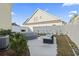 Landscaped backyard with hot tub and modern outdoor furniture with white vinyl fence at 724 Hobonny Loop, Longs, SC 29568