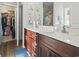 Bathroom featuring double sinks, modern fixtures, and a closet for storage at 724 Hobonny Loop, Longs, SC 29568