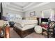 Spacious bedroom featuring a tray ceiling, large bed, and natural light from multiple windows at 724 Hobonny Loop, Longs, SC 29568