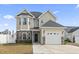 Charming home with stone accents, well-maintained landscaping, and an American flag displayed at 724 Hobonny Loop, Longs, SC 29568
