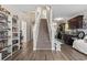 Inviting foyer with hardwood floors, staircase, and built-in shelving, leading to a modern kitchen at 724 Hobonny Loop, Longs, SC 29568
