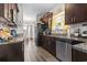 Modern kitchen with dark wood cabinets, granite countertops, and an open design leading to the dining area at 724 Hobonny Loop, Longs, SC 29568