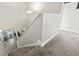 Carpeted staircase with white banister, leading upstairs to a well-lit landing at 724 Hobonny Loop, Longs, SC 29568