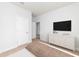 Minimalist bedroom with a white dresser, TV, and neutral carpet flooring at 1002 Laconic Dr., Myrtle Beach, SC 29588
