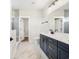 Modern bathroom with navy double vanity and marble floors at 1017 Tarpon Pond Rd., North Myrtle Beach, SC 29582