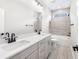 Modern bathroom with double vanity, bathtub, and neutral tile at 1017 Tarpon Pond Rd., North Myrtle Beach, SC 29582