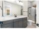 Modern bathroom with gray vanity, white countertop, and glass shower at 1017 Tarpon Pond Rd., North Myrtle Beach, SC 29582