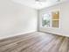Bedroom with hardwood floors and large window, under construction at 1017 Tarpon Pond Rd., North Myrtle Beach, SC 29582