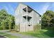 Two-story light green house with a detached garage and landscaping at 1017 Tarpon Pond Rd., North Myrtle Beach, SC 29582