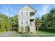 Two-story light green house with a detached garage and landscaping at 1017 Tarpon Pond Rd., North Myrtle Beach, SC 29582