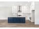 Modern kitchen with white and blue cabinetry and large island at 1017 Tarpon Pond Rd., North Myrtle Beach, SC 29582