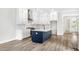 Modern kitchen with white and blue cabinetry and large island at 1017 Tarpon Pond Rd., North Myrtle Beach, SC 29582