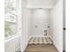 Bright laundry room with patterned floor tile and ample shelving at 1017 Tarpon Pond Rd., North Myrtle Beach, SC 29582