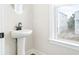 Stylish powder room with pedestal sink and window at 1017 Tarpon Pond Rd., North Myrtle Beach, SC 29582