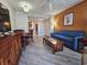 Cozy living room featuring a sofa, wooden furniture, and a view into the kitchen area at 5200 N Ocean Blvd. # 932, Myrtle Beach, SC 29577