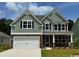 Charming two-story home features a two-car garage and manicured lawn at 561 Slaty Dr., Myrtle Beach, SC 29588