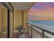 Cozy balcony features ocean views, with a comfortable chair and small table, creating an ideal retreat at 6900 N Ocean Blvd. # 1135, Myrtle Beach, SC 29572