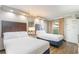 Inviting bedroom with two beds, soft lighting, and a view of the building next door at 6900 N Ocean Blvd. # 1135, Myrtle Beach, SC 29572