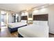 Cozy bedroom featuring two queen beds, soft lighting, and a serene ambiance at 6900 N Ocean Blvd. # 1135, Myrtle Beach, SC 29572