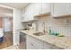 Modern kitchen with granite countertops, subway tile backsplash, and stainless steel appliances at 6900 N Ocean Blvd. # 1135, Myrtle Beach, SC 29572